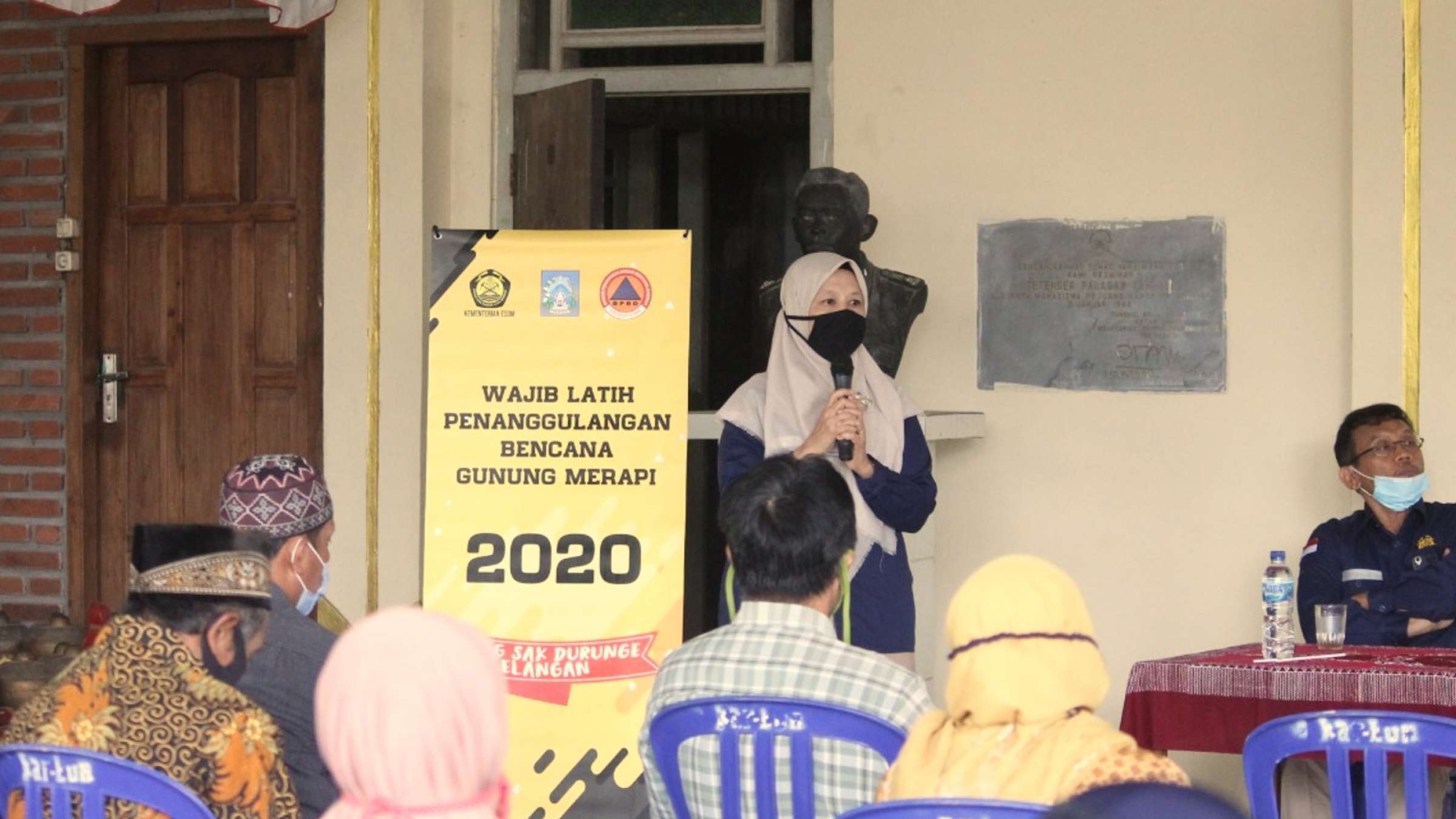 indonesian woman presents in front of a group